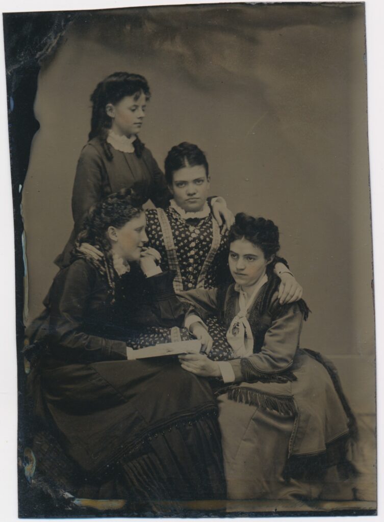 View the photos 1 van Unknown: four young women with a photo album, Netherlands ca. 1875