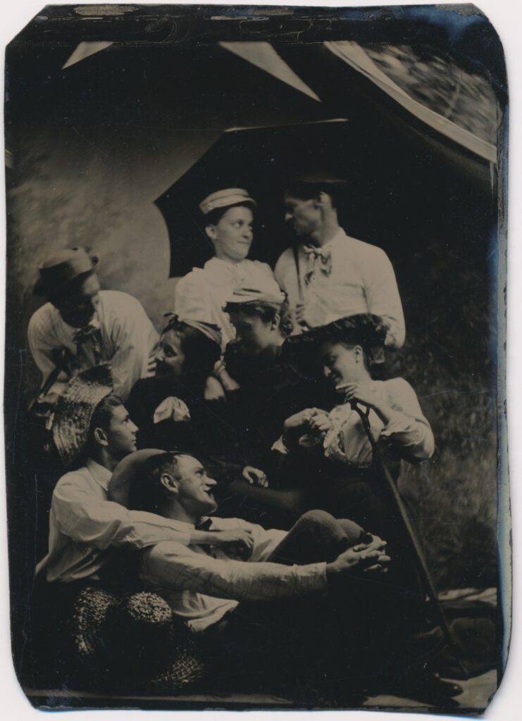 View the photos 1 van Unknown: group of young people under a canvas awning, Netherlands ca. 1875